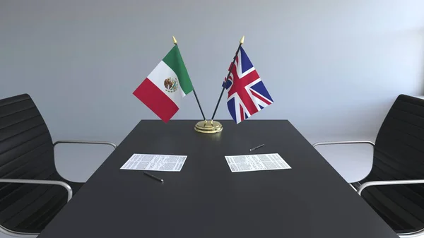 Banderas de México y el Reino Unido y documentos sobre la mesa. Negociaciones y firma de un acuerdo internacional. Renderizado 3D conceptual —  Fotos de Stock