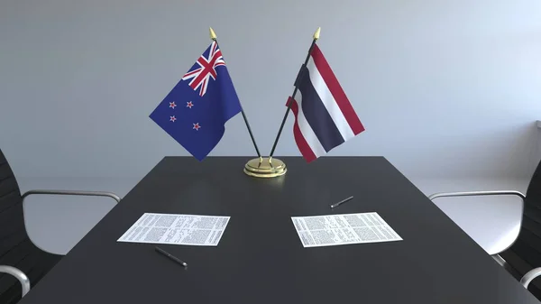 Flaggor av nya Zeeland och Thailand och papper på bordet. Förhandlingarna och underteckna internationella avtal. Konceptuell 3d-rendering — Stockfoto