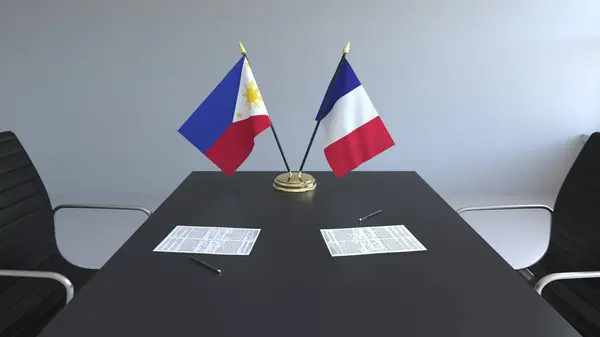 菲律宾和法国的国旗和桌上的文件。谈判和签署一项国际协定。概念3d 渲染 — 图库照片