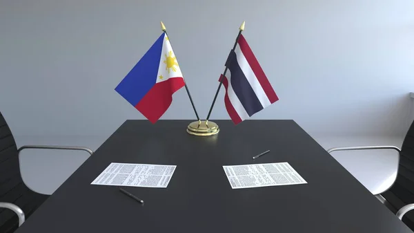 菲律宾和泰国的国旗和桌上的文件。谈判和签署一项国际协定。概念3d 渲染 — 图库照片
