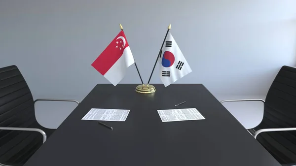 Flaggen von Singapore und Südkorea und Papiere auf dem Tisch. Verhandlungen und die Unterzeichnung eines internationalen Abkommens. konzeptionelles 3D-Rendering — Stockfoto