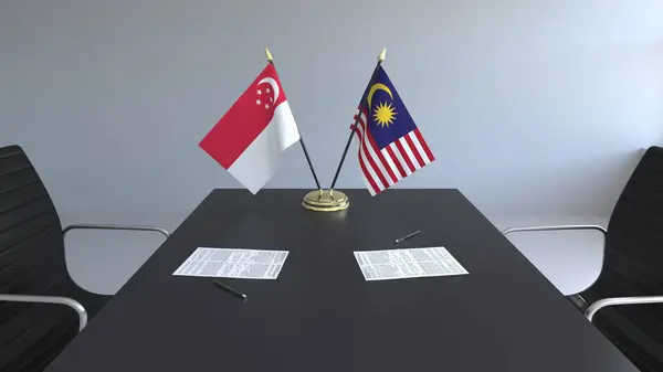 Flaggor av Singapore och Malaysia och papper på bordet. Förhandlingarna och underteckna internationella avtal. Konceptuell 3d-rendering — Stockfoto