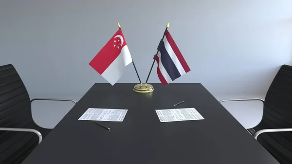 Flaggen von Singapore und Thailand und Papiere auf dem Tisch. Verhandlungen und die Unterzeichnung eines internationalen Abkommens. konzeptionelles 3D-Rendering — Stockfoto