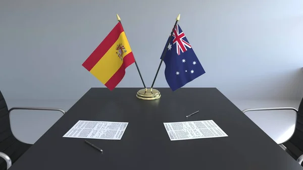 Bandiere di Spagna e Australia e documenti sul tavolo. Negoziati e firma di un accordo internazionale. Rendering 3D concettuale — Foto Stock