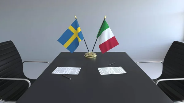 テーブルの上の論文とイタリア スウェーデンの国旗。交渉と国際協定に署名します。概念 3 d レンダリング — ストック写真
