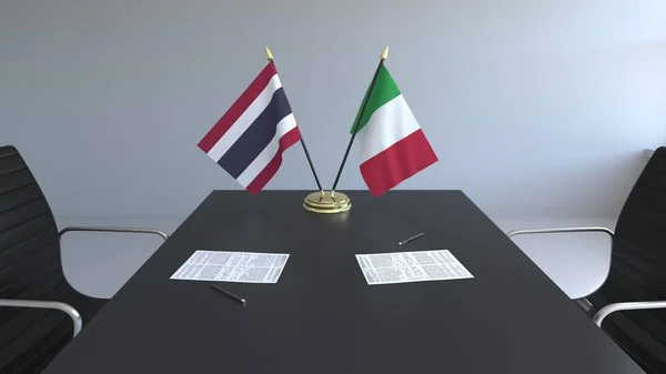 Flaggen von Thailand und Italien und Papiere auf dem Tisch. Verhandlungen und die Unterzeichnung eines internationalen Abkommens. konzeptionelles 3D-Rendering — Stockfoto
