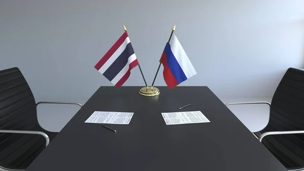 Flags of Thailand and Russia and papers on the table. Negotiations and signing an international agreement. Conceptual 3D rendering — Stock Photo, Image