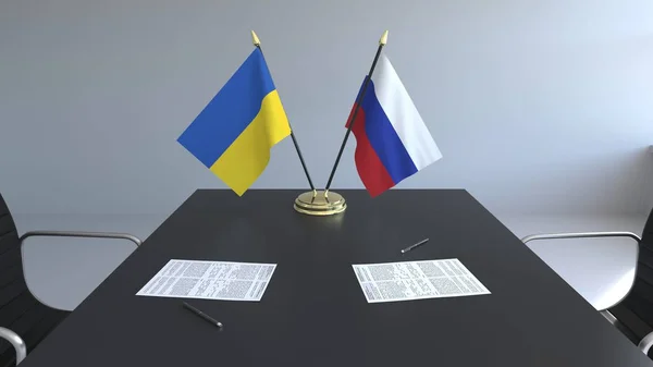 ウクライナやロシアなど、テーブルの上の論文のフラグです。交渉と国際協定に署名します。概念 3 d レンダリング — ストック写真
