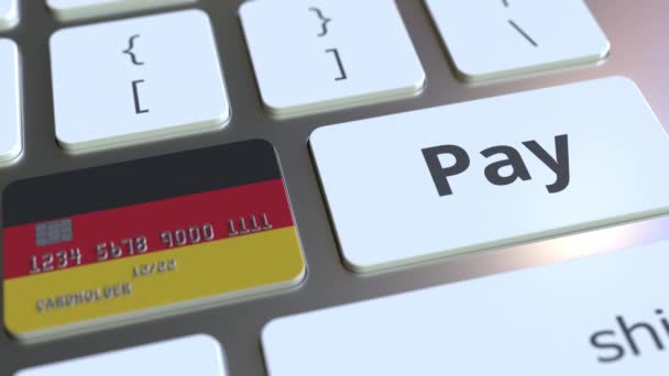 Tarjeta bancaria con la bandera de Alemania como una tecla en un teclado de ordenador. Animación conceptual de pago en línea alemana — Vídeo de stock