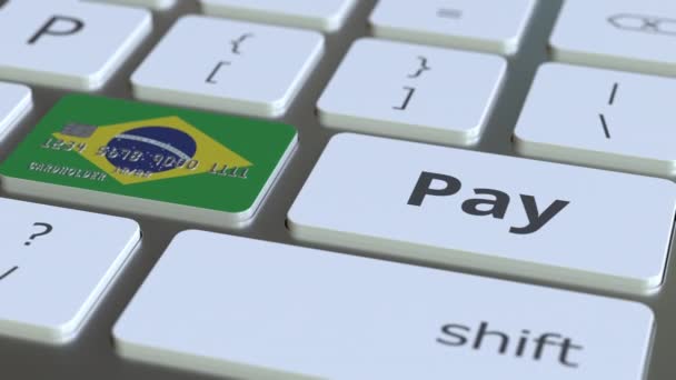 Bankkarte mit brasilianischer Flagge als Schlüssel auf einer Computertastatur. Konzeptionelle Animation des brasilianischen Online-Zahlungsverkehrs — Stockvideo