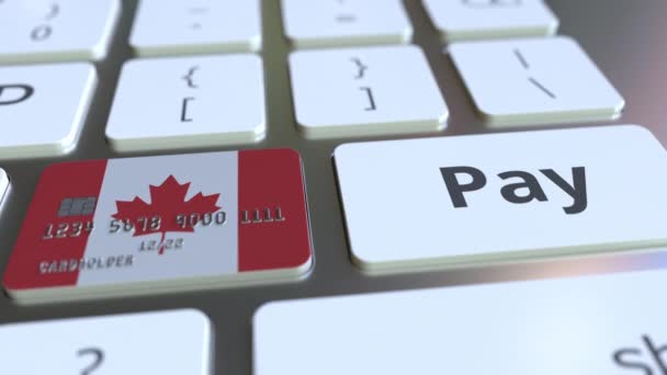Tarjeta bancaria con la bandera de Canadá como una tecla en un teclado de computadora. Animación conceptual de pago online canadiense — Vídeos de Stock