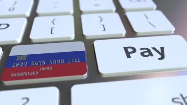 Bank card featuring flag of Russia as a key on a computer keyboard. Russian online payment conceptual animation — Stock Video