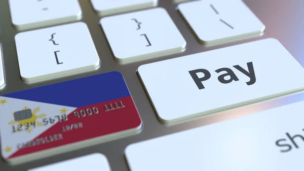Kartu bank menampilkan bendera Filipina sebagai kunci pada papan ketik komputer. Perenderan konseptual pembayaran daring 3D — Stok Foto