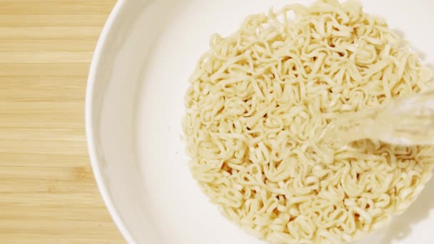 Adding hot water to instant noodles, top down view. Slow motion shot — Stock Video
