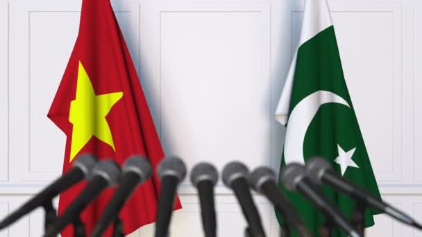 Флаги Вьетнама и Пакистана на международной встрече или пресс-конференции переговоров. 3D анимация — стоковое видео