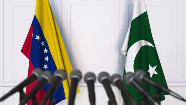Bandiere del Venezuela e del Pakistan alla riunione internazionale o alla conferenza stampa dei negoziati. Animazione 3D — Video Stock