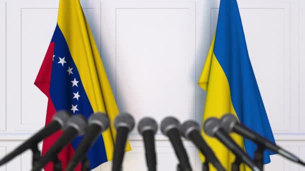 Flags of Venezuela and Ukraine at international meeting or negotiations press conference. 3D animation — Stock Video