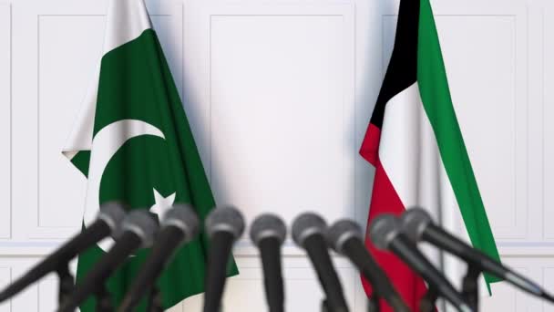 Vlajky z Pákistánu a Kuvajtu na mezinárodní tiskové konferenci zasedání nebo jednání. 3D animace — Stock video