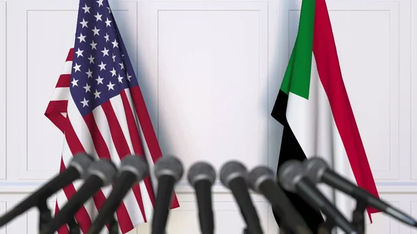 Flags of the United States and Sudan at international meeting or negotiations press conference. 3D rendering — Stock Photo, Image