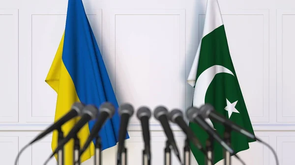 Bandeiras da Ucrânia e do Paquistão em reunião internacional ou negociações conferência de imprensa. Renderização 3D — Fotografia de Stock