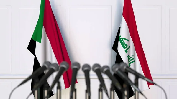 国際会議や交渉の記者会見でスーダン、イラクの国旗。3 d レンダリング — ストック写真