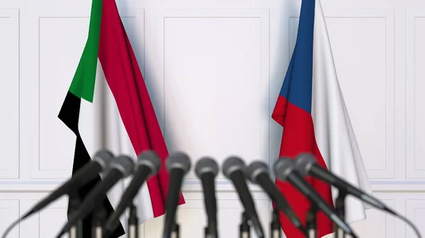 Σημαίες του Σουδάν και της Τσεχικής Δημοκρατίας σε διεθνή διάσκεψη τύπου συνάντησης ή διαπραγματεύσεις. 3D rendering — Φωτογραφία Αρχείου