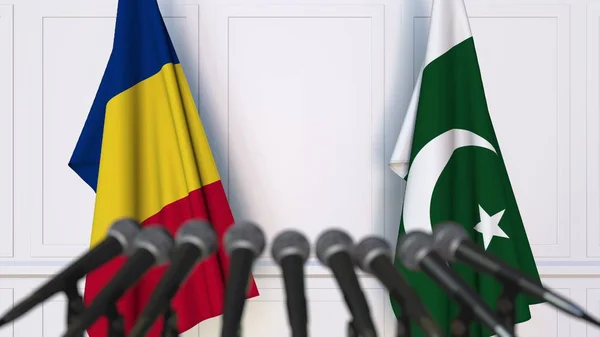 Flags of Romania and Pakistan at international meeting or negotiations press conference. 3D rendering — Stock Photo, Image