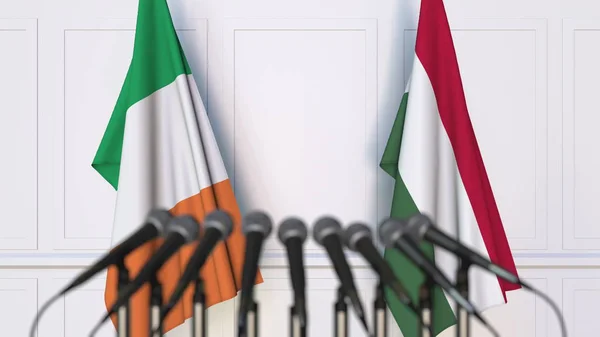 爱尔兰和匈牙利国旗在国际会议或谈判新闻发布会上。3d 渲染 — 图库照片