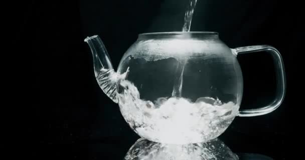 Fazendo chá florescendo em um bule de vidro. Derramando água quente — Vídeo de Stock