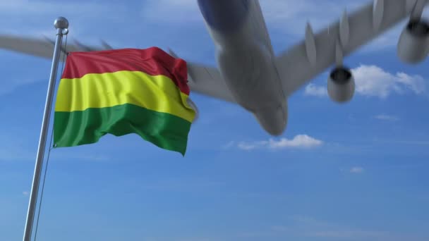 Airplane flies over waving flag of Bolivia. 3D animation — Stock Video