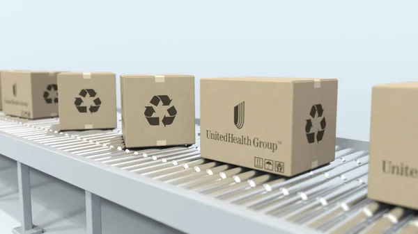 Λογότυπο ομάδας μονάδας υγείας σε κινούμενα κουτιά σε κύλινδρο μεταφορέα. Συντακτική απόδοση 3D — Φωτογραφία Αρχείου