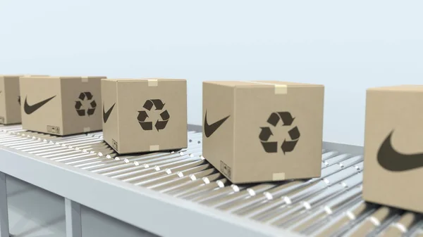 Kartons met Nike-logo te verplaatsen op roller transportband. Redactionele 3D rendering — Stockfoto