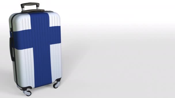 Travelers suitcase with flag of Finland. Finnish tourism conceptual 3D animation, blank space for caption — Stock Video