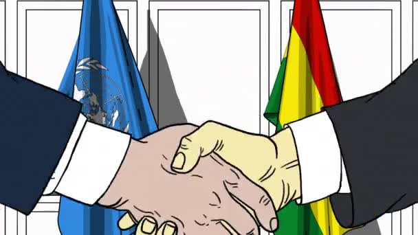 Businessmen or politicians shake hands against flags of United Nations and Bolivia. Official meeting or cooperation related editorial animation — Stock Video