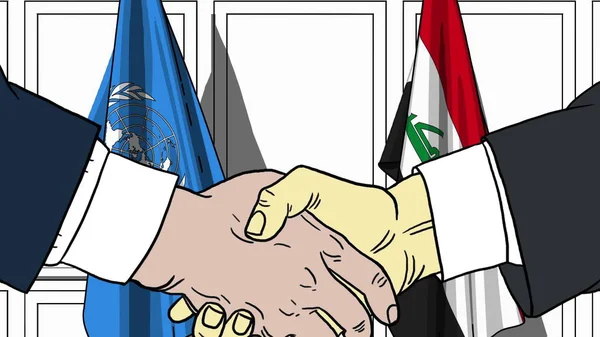 Des hommes d'affaires ou des politiciens serrent la main contre les drapeaux des Nations Unies et de l'Irak. Réunion officielle ou illustration éditoriale liée à la coopération — Photo