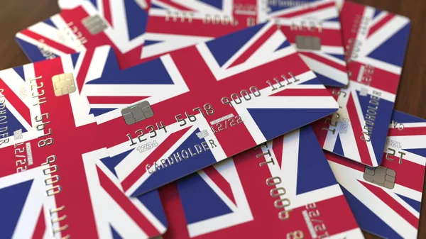 Högen av kreditkort med flagga av Storbritannien. British banking system konceptuella 3D-rendering — Stockfoto