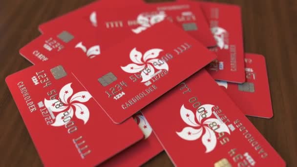 Montón de tarjetas de crédito con bandera de Hong Kong. Sistema bancario animación conceptual 3D — Vídeo de stock