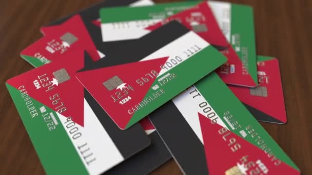 Montón de tarjetas de crédito con bandera de Jordania. Sistema bancario jordano animación 3D conceptual — Vídeo de stock