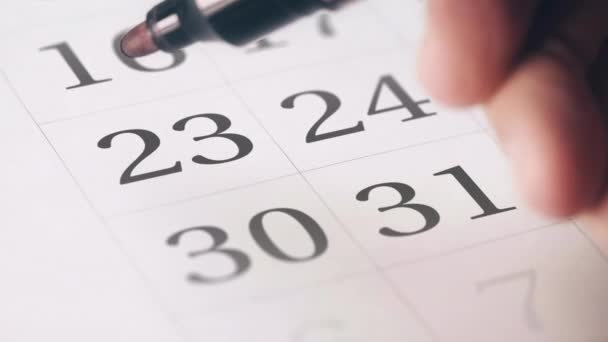 Drawing red circled mark on the twenty-third 23 day of a month in the calendar — Stock Video