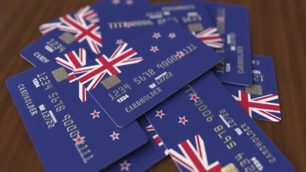 Pile of credit cards with flag of New Zealand. National banking system conceptual 3D animation — Stock Video