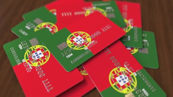 Montón de tarjetas de crédito con bandera de Portugal. Sistema bancario portugués animación 3D conceptual — Vídeo de stock