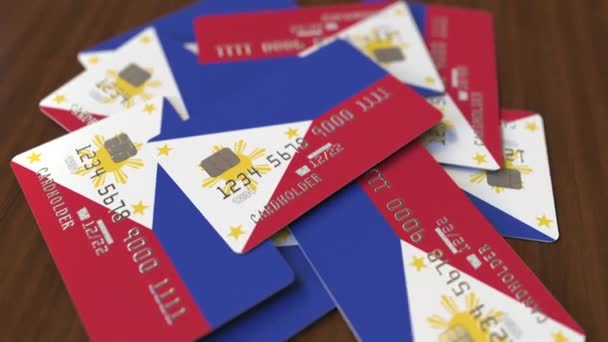 Montón de tarjetas de crédito con bandera de Filipinas. Sistema bancario nacional animación conceptual 3D — Vídeos de Stock