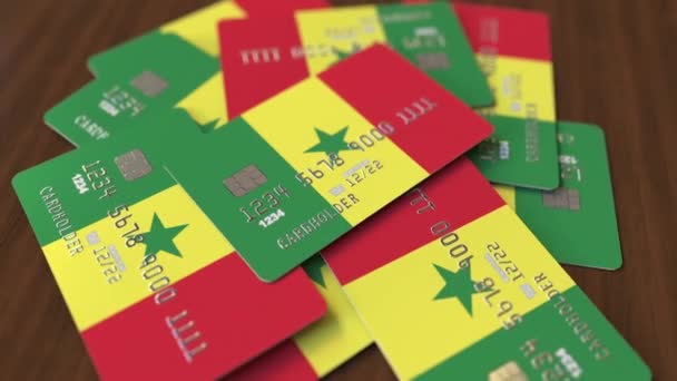 Stapel creditcards met vlag van Senegal. Senegalebanksysteem conceptuele 3D-animatie — Stockvideo