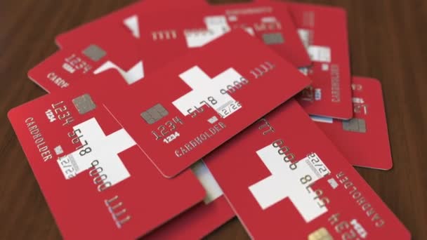 Mucchio di carte di credito con bandiera della Svizzera. Sistema bancario svizzero concettuale animazione 3D — Video Stock