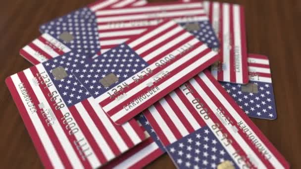 Montón de tarjetas de crédito con bandera de los Estados Unidos. Sistema bancario estadounidense animación 3D conceptual — Vídeo de stock