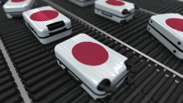 Resväskor med Japans flagga rör sig på transportbandet på en flygplats. Japansk turism relaterade 3D-rendering — Stockfoto