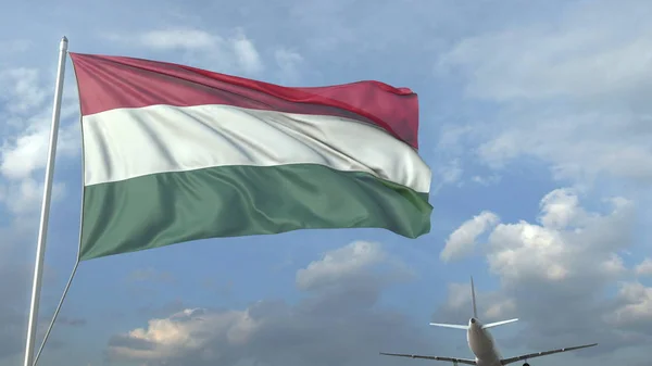 Avião que sobrevoa a bandeira da Hungria. Renderização 3D — Fotografia de Stock