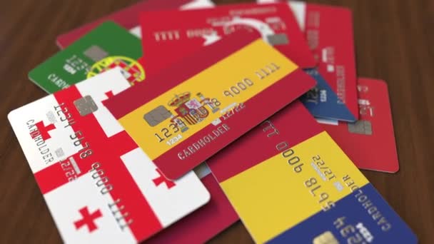 Many credit cards with different flags, emphasized bank card with flag of Spain — Stock Video