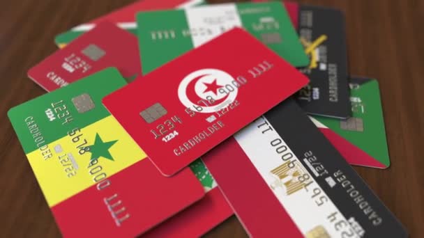 Řada kreditních karet s odlišnými vlajkami, zdůrazněný bankovní kartou s Tuniskou vlajkou — Stock video