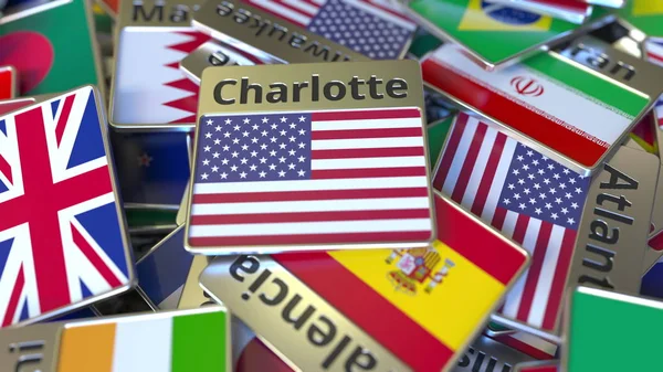 Imán de recuerdo o insignia con texto Charlotte y bandera nacional entre diferentes. Viajar a los Estados Unidos renderizado 3D conceptual —  Fotos de Stock